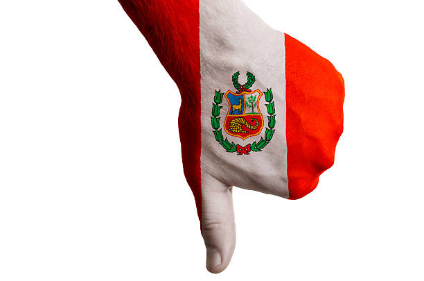 Hand with thumbs down gesture in colored peru national flag as symbol of negative political, cultural, social management of country
