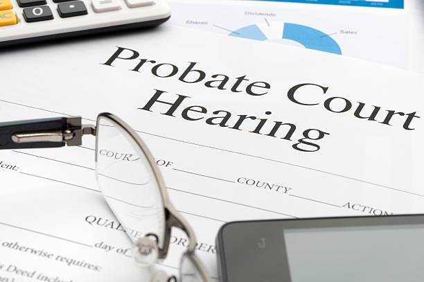 Probate court hearing form on a desk. Probate court hearing form on a desk. Probate court hearing form on a desk with a calculator, pen, glasses, mobile phone and digital tablet. probate photos stock pictures, royalty-free photos & images