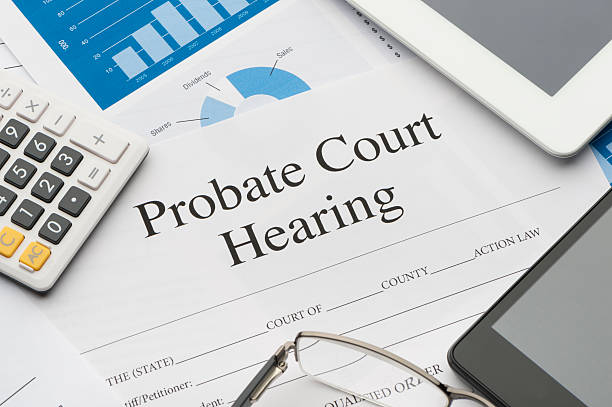 Probate court hearing form on a desk. Probate court hearing form on a desk. estate lawyers flat fee Probate court hearing form on a desk with a calculator, pen, glasses, mobile phone and digital tablet. Probate Court Proceedings stock pictures, royalty-free photos & images