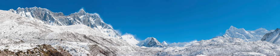 The saw tooth ridge of Nuptse (7861m) and the jagged summit of Lhotse (8516m) overlooking the snow capped peak of Makalu (8481m), Baruntse (7219m), Island Peak (6189m), Ama Dablam (6812m), Pokalde (5806m) and the dramatic white wilderness of the Himalaya mountains in Solu Khumbu, Nepal. ProPhoto RGB profile for maximum color fidelity and gamut.