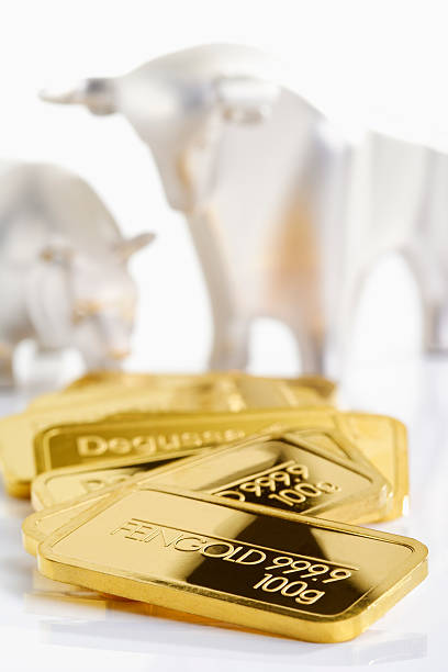 istock Gold bars in front of bull and bear 466213524