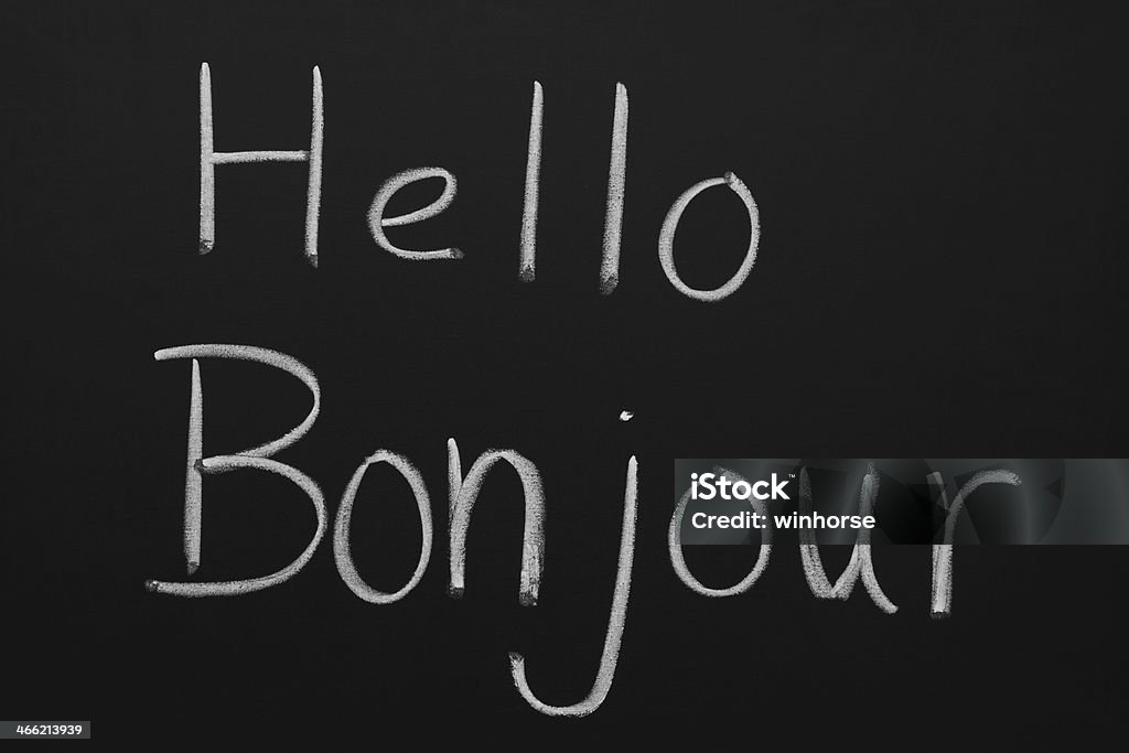Hello and Bonjour Hello and Bonjour written on a blackboard. Greeting Stock Photo