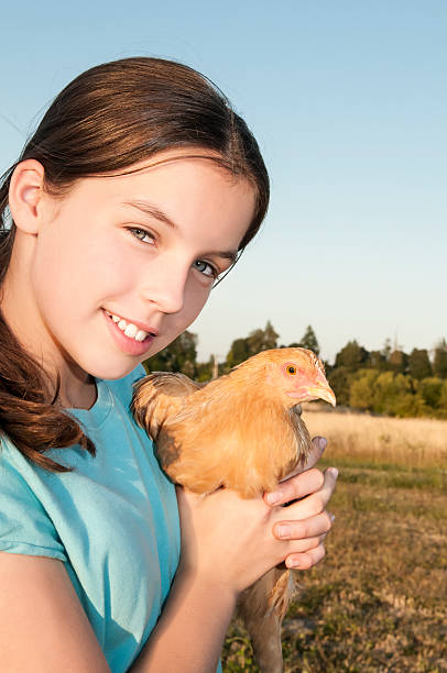 istock Girl Holding Hen 466213963