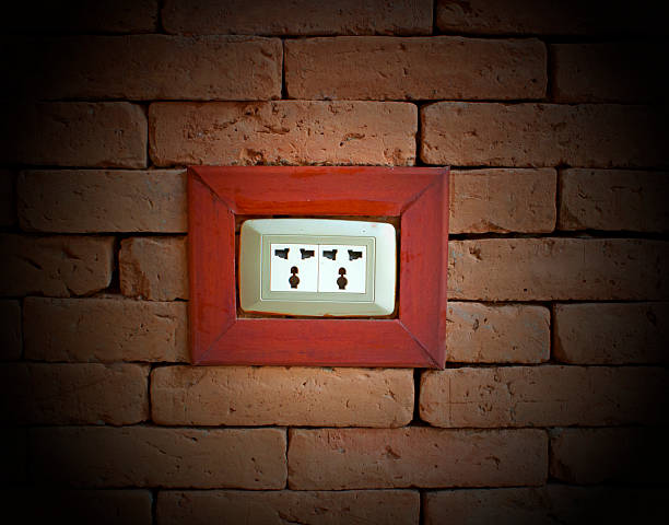 Electrical outlet. electrical outlet on a wall of red brick. Faceplate stock pictures, royalty-free photos & images