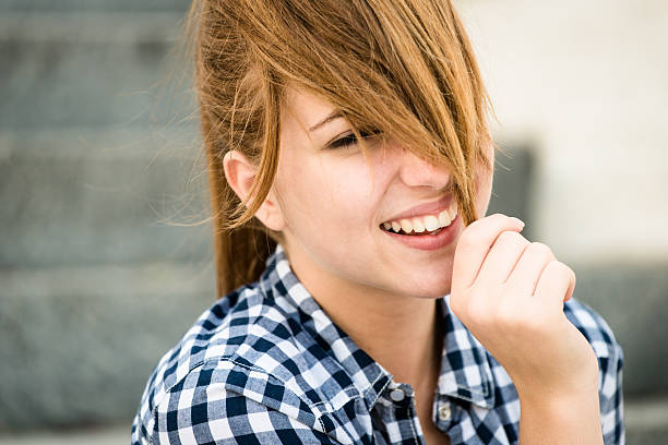 istock Young woman playing with hair 466214458