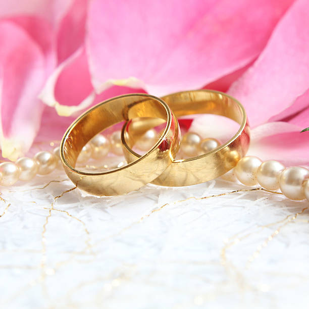 istock pair of wedding rings with roses for background image 466214856