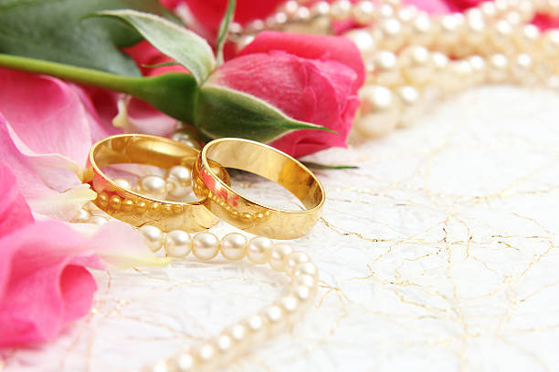 istock pair of wedding rings with roses for background image 466214858
