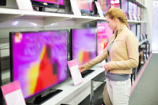 The woman buys a TV in shop