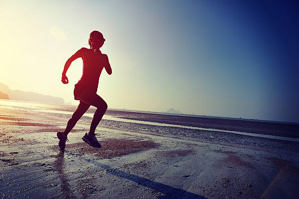 istock Young fit woman running on the beach 466216470
