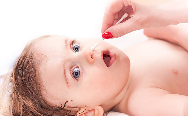 istock cleaning the nose a little child 466218978