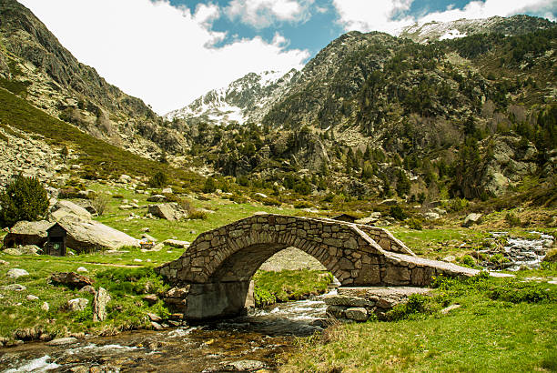 snow capped mountains with river and bridge snow capped mountains with river and a stone bridge andorra photos stock pictures, royalty-free photos & images