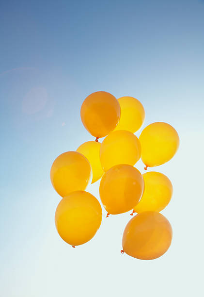 istock yellow balloons in the blue sky 466221823