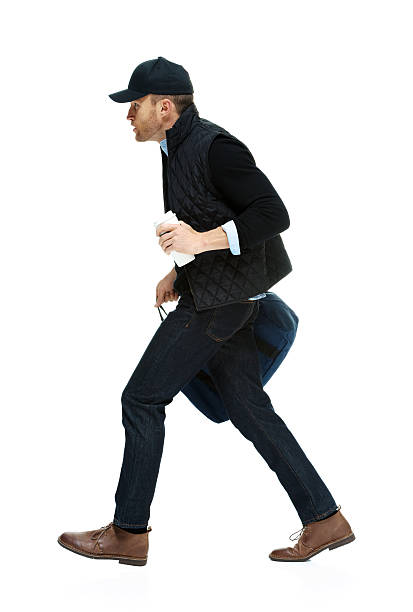istock Casual man walking with coffee cup and duffle bag 466222430