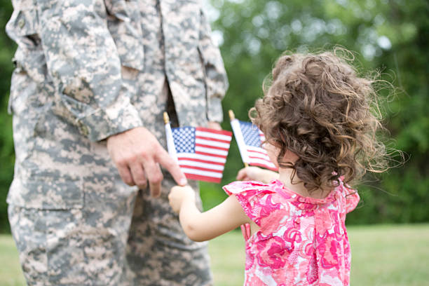 istock little girl wit soldier 466222523