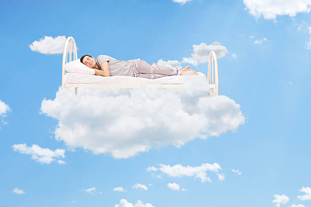 istock A man sleeping in a bed of clouds 466222662