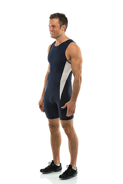 istock Smiling young male athlete posing against white 466223339