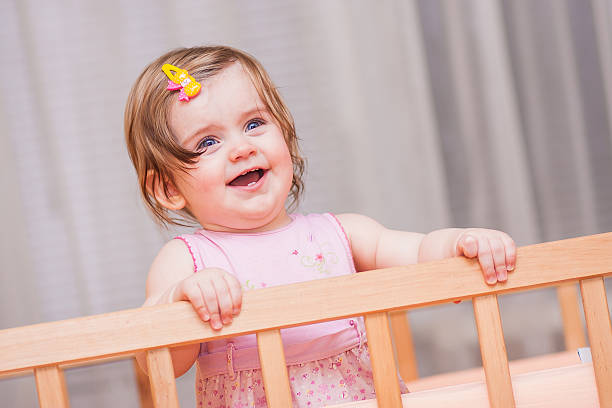istock small child with a hairpin standing in crib. 466224092