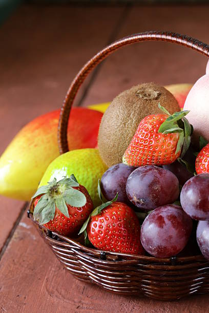 istock still life wicker basket with fruit on a wooden table 466226405