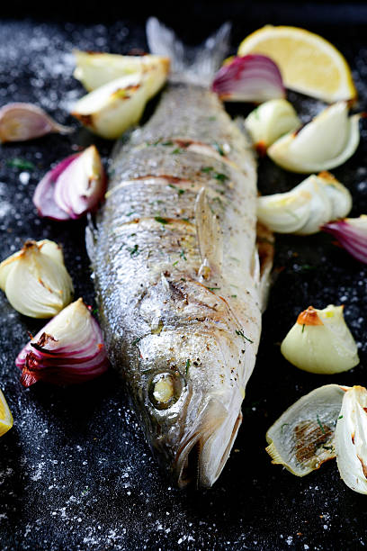 istock Roasted Sea Bass on a dark tray 466227104