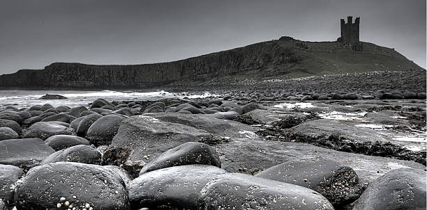 istock Dunstanburgh Castle and rocky seashore 466227189