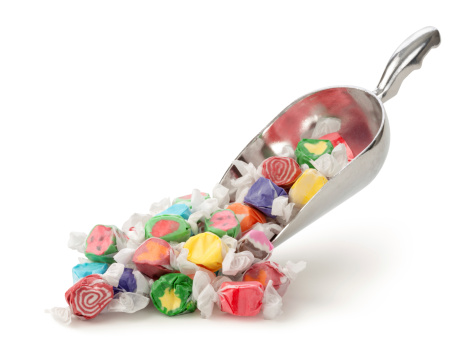 Salt Water Taffy in a scoop isolated on a white background.