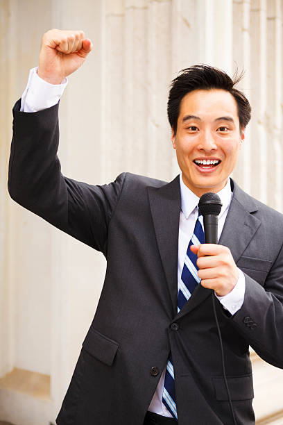 istock Happy Man with Microphone and Raised Fist 466228787