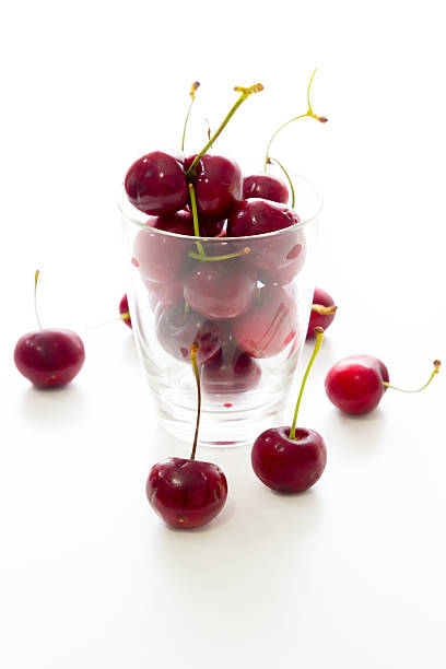 istock Cherry in a glass container isolated on white 466229127