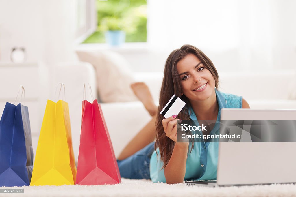 Beautiful woman paying by credit card for shopping at home Beautiful woman paying by credit card for shopping at home  Adult Stock Photo