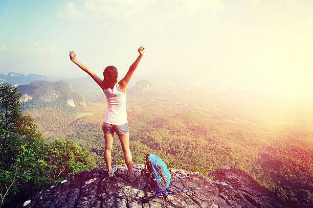istock cheering hiking woman on mountain peak 466234750