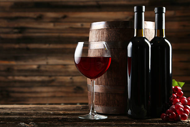istock Red wine glass with bottle and barrel 466234966