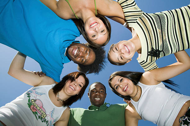 istock Friends Forming Huddle Against Blue Sky 466235387