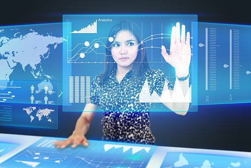Businesswoman dragging an icon on a touch screen monitor. conceptual image