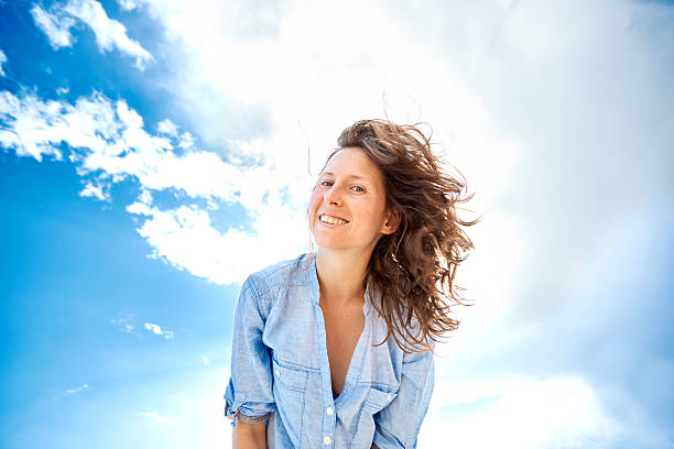 istock woman against blue sky 466238140