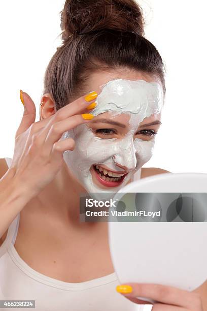 Young Woman Enjoys Applying Face Mask Stock Photo - Download Image Now - 2015, Adult, Alternative Therapy