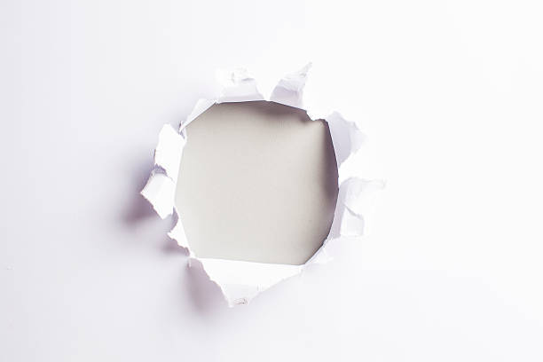 istock White card/paper with torn hole in the middle, colourful background 466239064