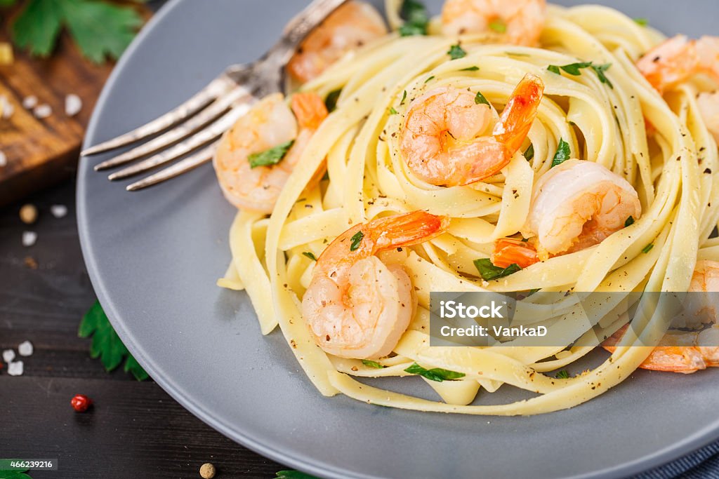 Tagliatelle with shrimps and parsley Tagliatelle with shrimps and parsley on a plate Tagliatelle Stock Photo