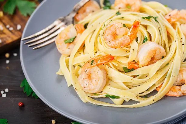 Tagliatelle with shrimps and parsley on a plate