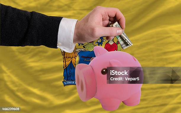 Dollar Into Piggy Coin Bank And Flag Of New Jersey Stock Photo - Download Image Now - 2015, Adult, Anxiety