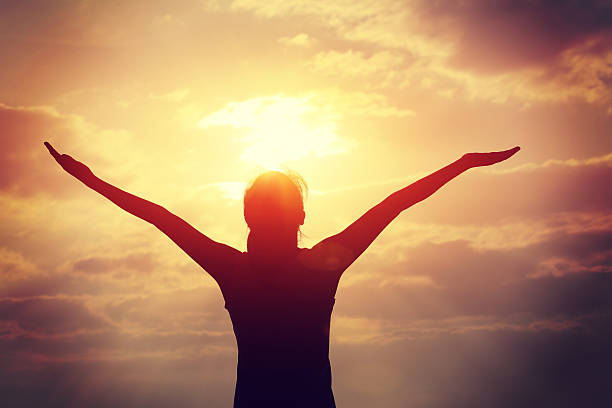 istock strong confident woman open arms to sunrise at sea 466240572