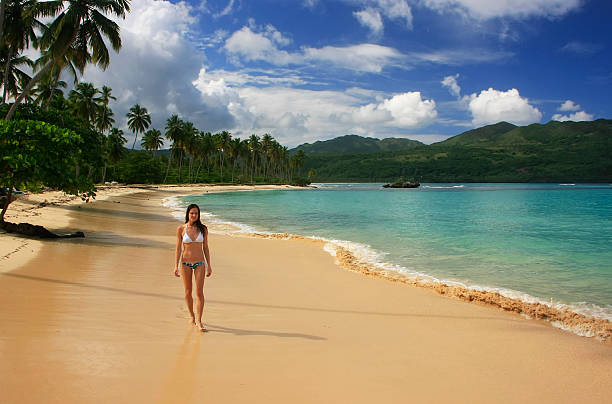 istock Young woman in bikini walking at Rincon beach, Samana peninsula 466241179