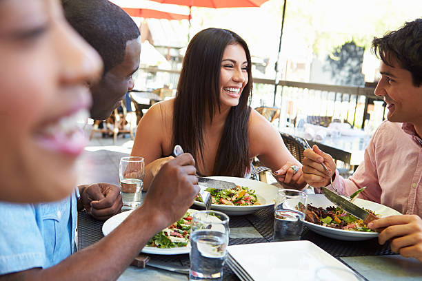 istock Woman smiling with friends at lunch 466241423