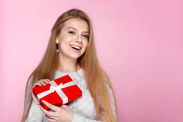 istock JJoyful girl gift box pink background, Valentines Day, Women's Day 466243630