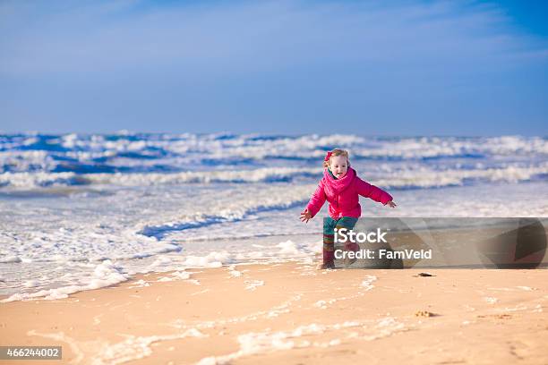 Little Girl At A Beach In Winter Stock Photo - Download Image Now - 2015, Autumn, Baby - Human Age