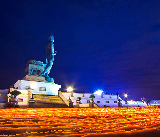 istock Buddha statue candle lit in lent day thailand 466244337
