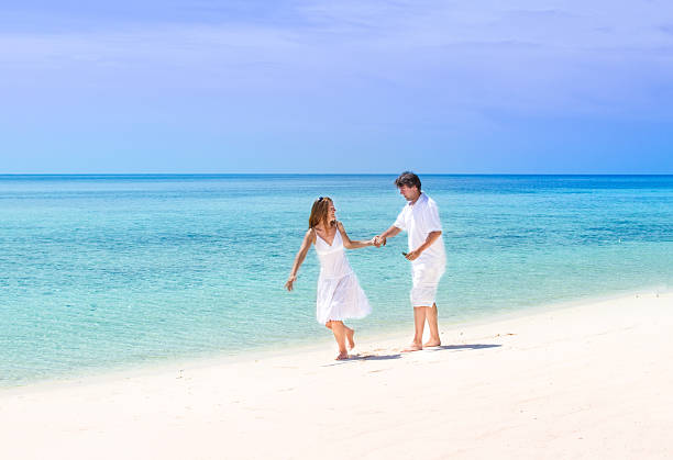istock Beautiful young couple running on a tropical beach 466244555