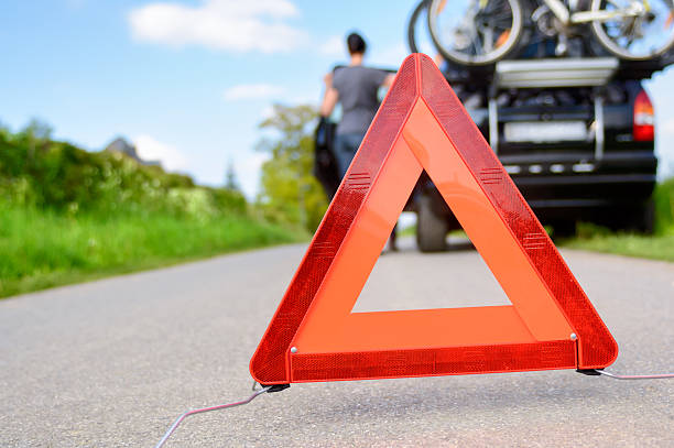 istock A person with a caution sign do to car trouble 466245786