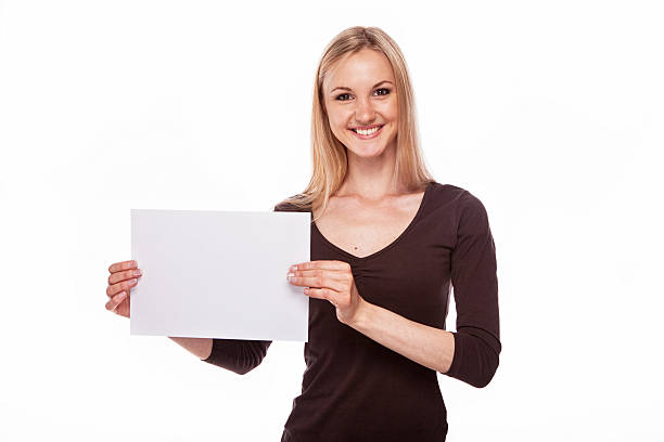 istock Smiling woman show big blank board 466246224