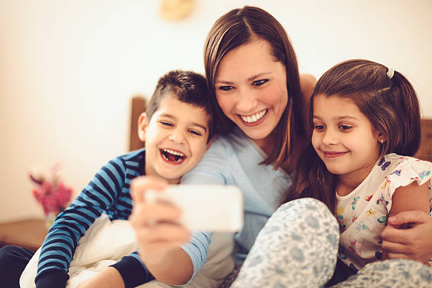 istock Proud mother takes selfies with her children 466247082