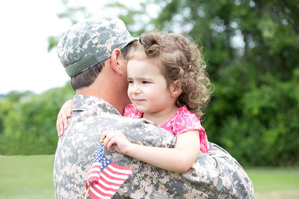 istock little girl hugging soldier 466249471
