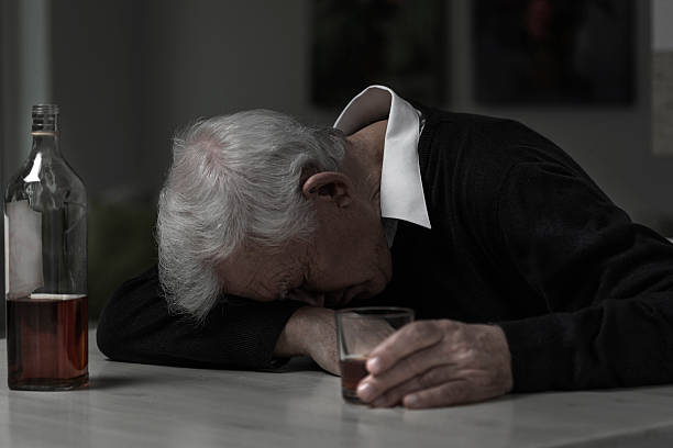 Old man alcoholic Old retired man alcoholic sleeping on the table divorcee stock pictures, royalty-free photos & images
